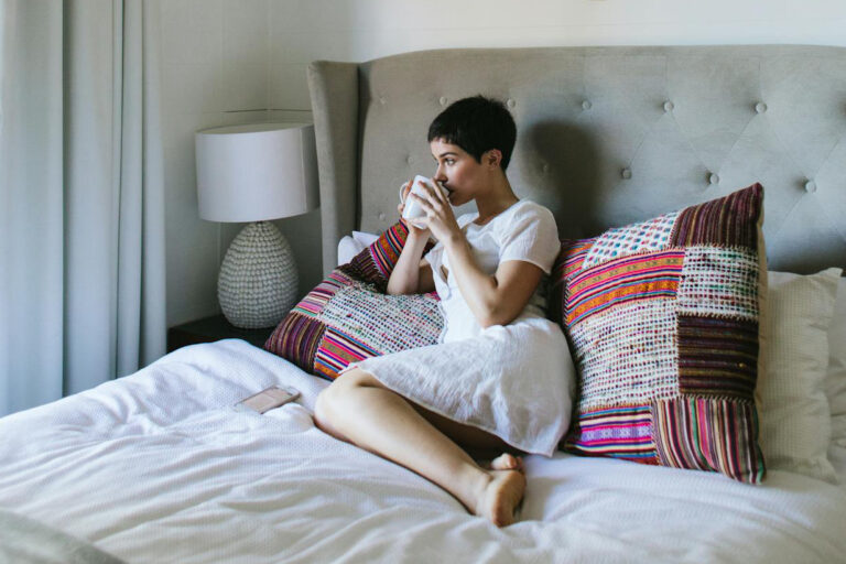 Sleep-Friendly Bedroom - a woman drinking the cup of tea.